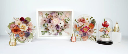 Different styles of flower preservation pieces including resin blocks